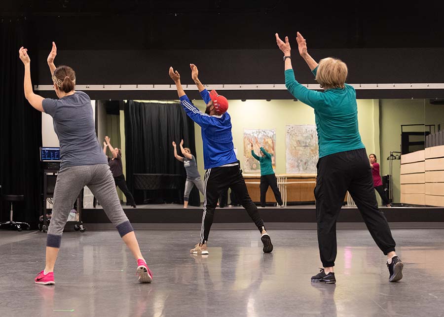 Group of adults performing choreography in dance class